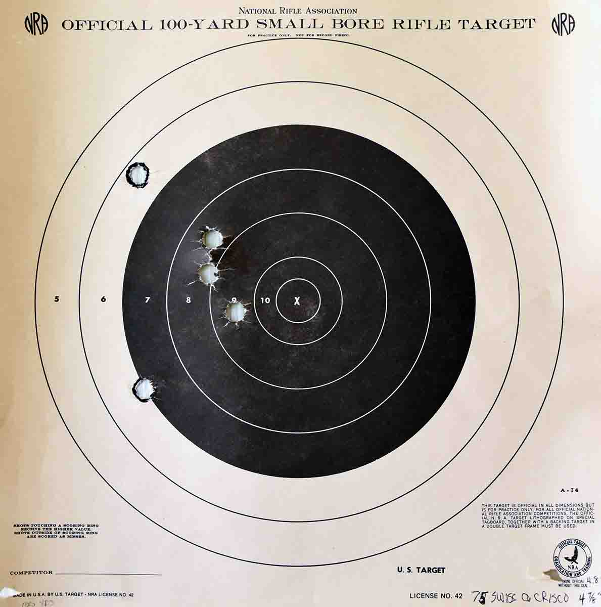 A typical 5-shot group at 100 yards with Crisco on top of the ball, measuring 47⁄8 inches. Tallow worked just as good, but I ran out of it.